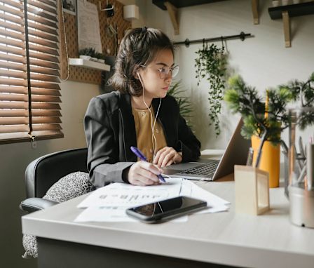 Accounting student working at desk on laptop