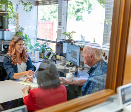 Accountant helping clients in her office