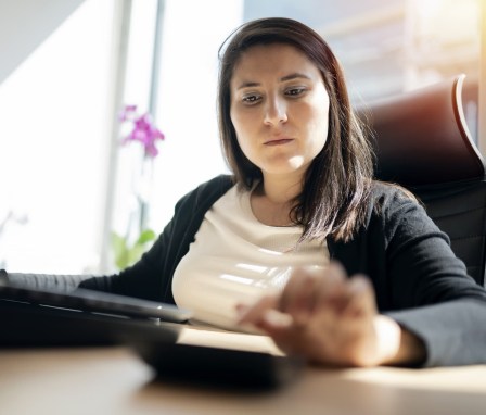 Businesswoman using calculator